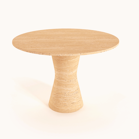 The Travertable Lunar Surface Round Travertine Dining Table features a sleek, wide top and a curved pedestal base, elegantly standing against a plain white background.
