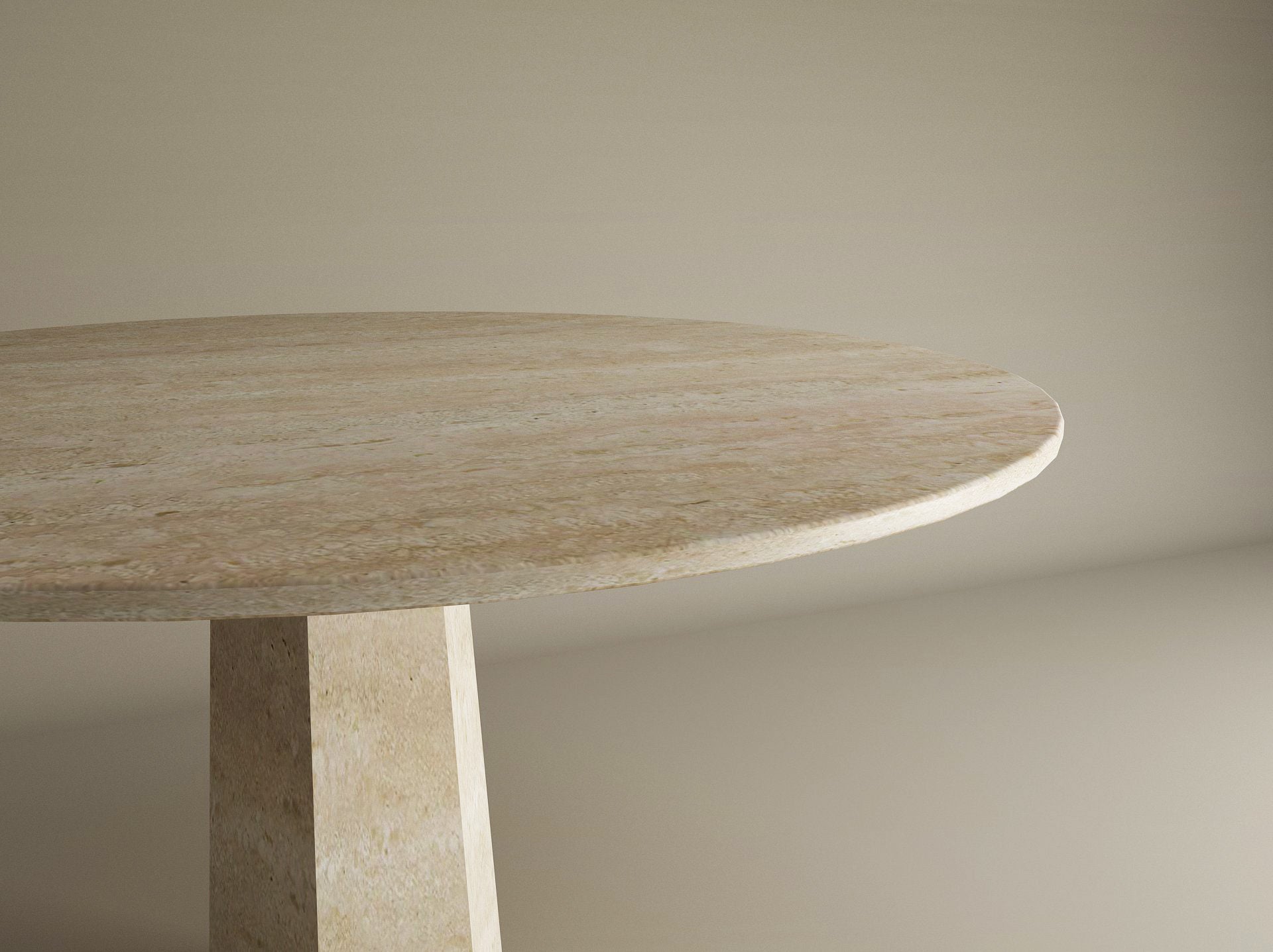 A close-up of the Oval Travertine Dining Table by TRAVERTABLE, featuring a travertine stone top and rockcone center base, shown against a plain beige background.