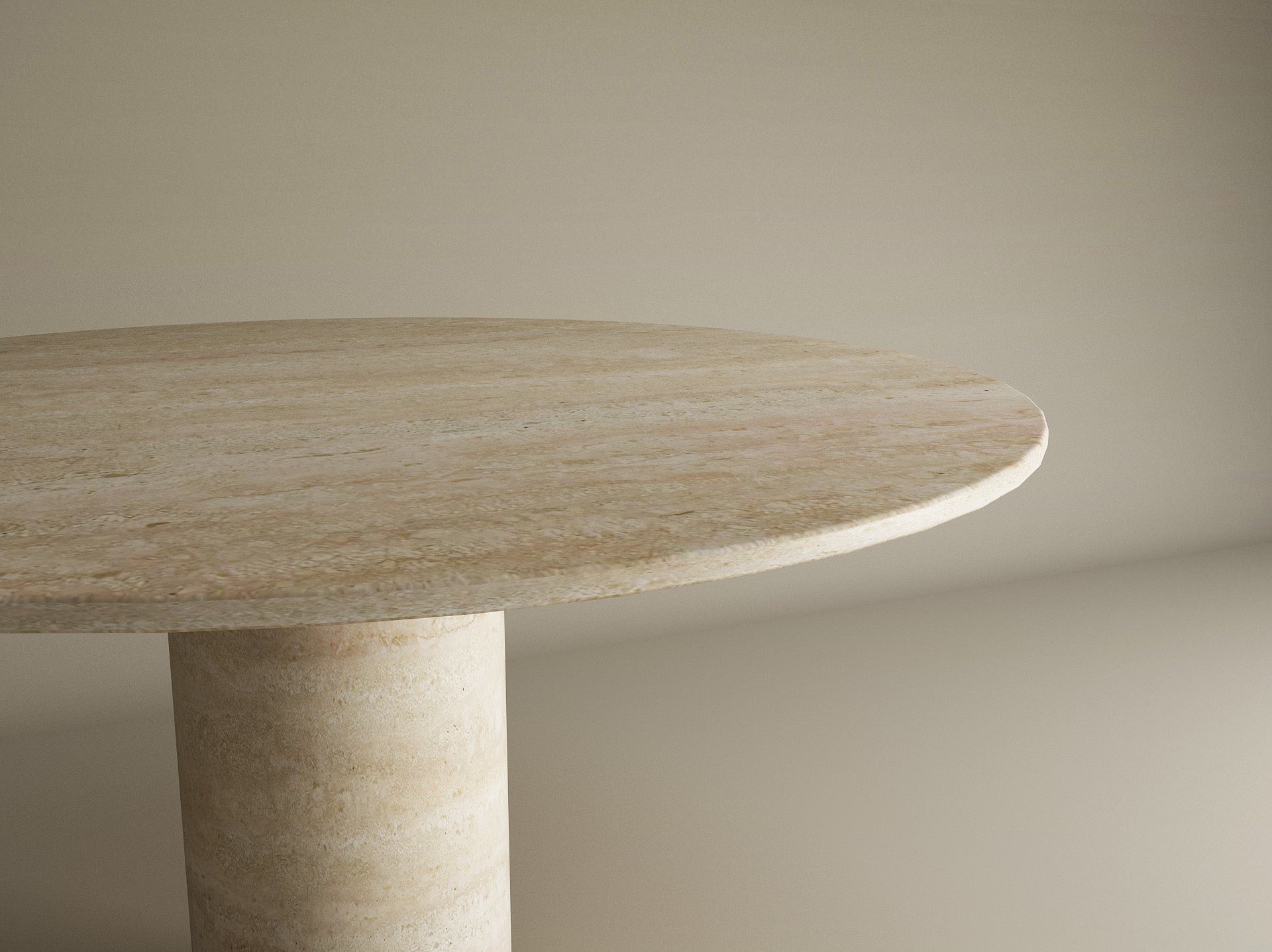 A close-up of the TRAVERTABLE Oval Travertine Dining Table, featuring a cylindrical center base and crafted from pure travertine stone. Only part of the table is visible, highlighting its elegant design—ideal for sophisticated dining spaces.