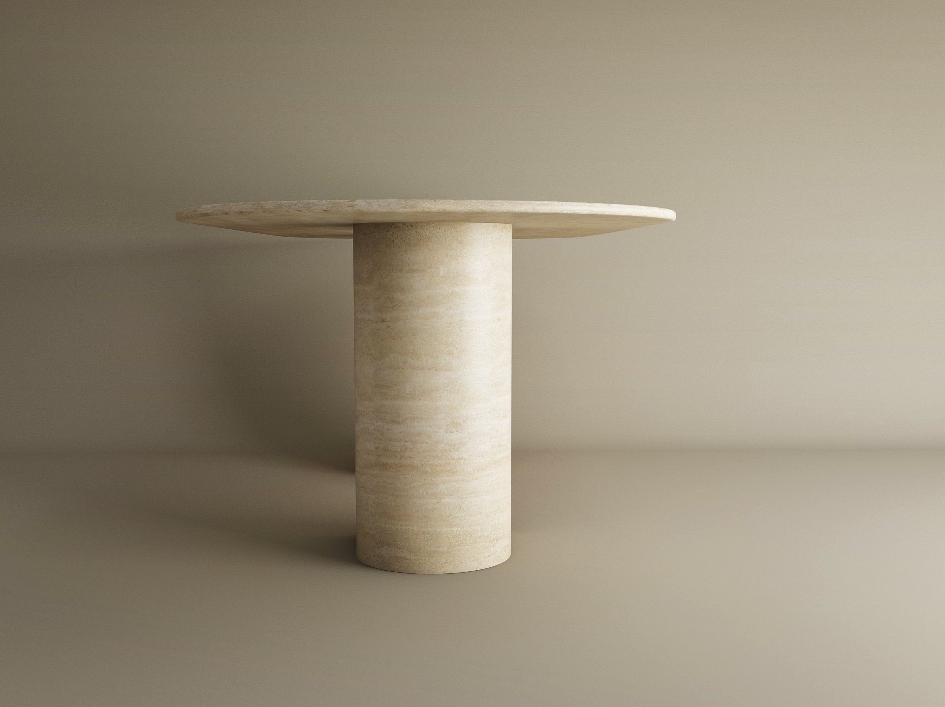 The TRAVERTABLE Oval Travertine Dining Table features a sloped natural stone pedestal base and matching tabletop in light beige, creating a timeless, customizable heirloom piece to elevate any space.