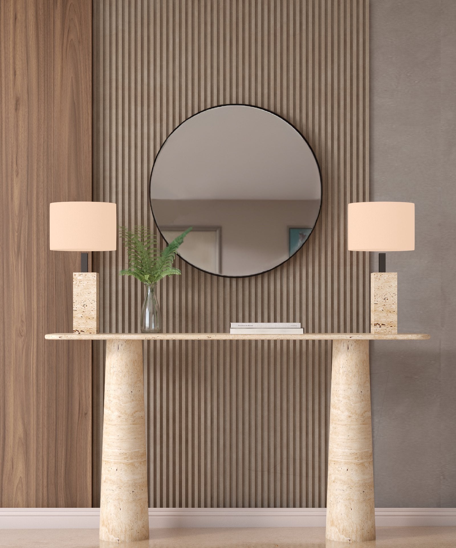 A modern entryway features a round mirror on a ribbed wood wall, the TRAVERTABLE Ovale Travertine Console Table with conical pedestal base, two beige rectangular-shade lamps, and a glass vase filled with green fern leaves.