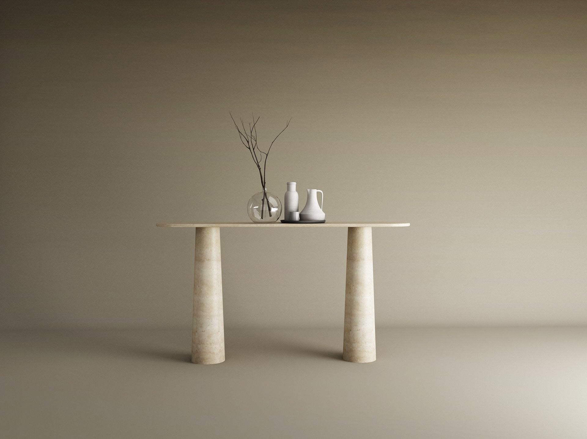 The Ovale Travertine Console Table by TRAVERTABLE features an organic travertine stone top and conical pedestal base. Three ceramic vases—one transparent, two opaque—with bare branches sit against a plain beige background.