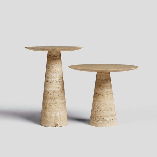 The Twin Pillars Travertine Side Table Set by Travertable exudes natural elegance against a gray backdrop, showcasing round tops with conical bases in beige and brown marble; one table is gracefully taller than the other.
