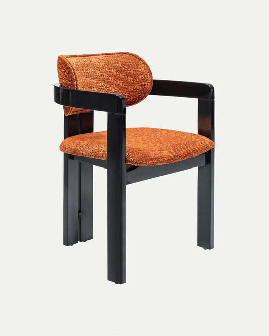 The Travertable Solaris Retro Chair boasts a modern ergonomic design with a round backrest and rectangular armrests. It is upholstered in orange textured fabric, and its sleek black frame enhances its contemporary, distinctive style.