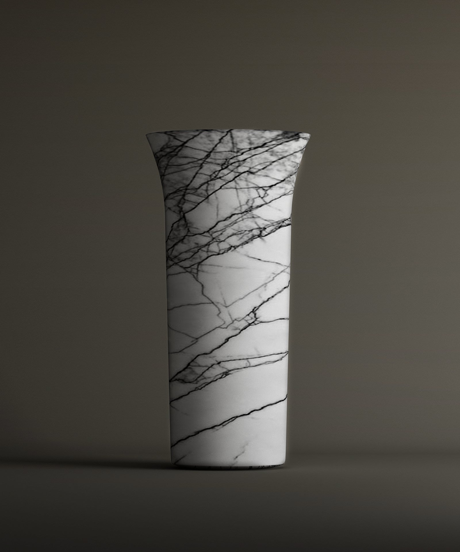 The TRAVERTABLE Lilac Marble Cylinder Pedestal Vanity Sink showcases striking black veining on white marble with a flared rim, set against a plain brownish-gray background.