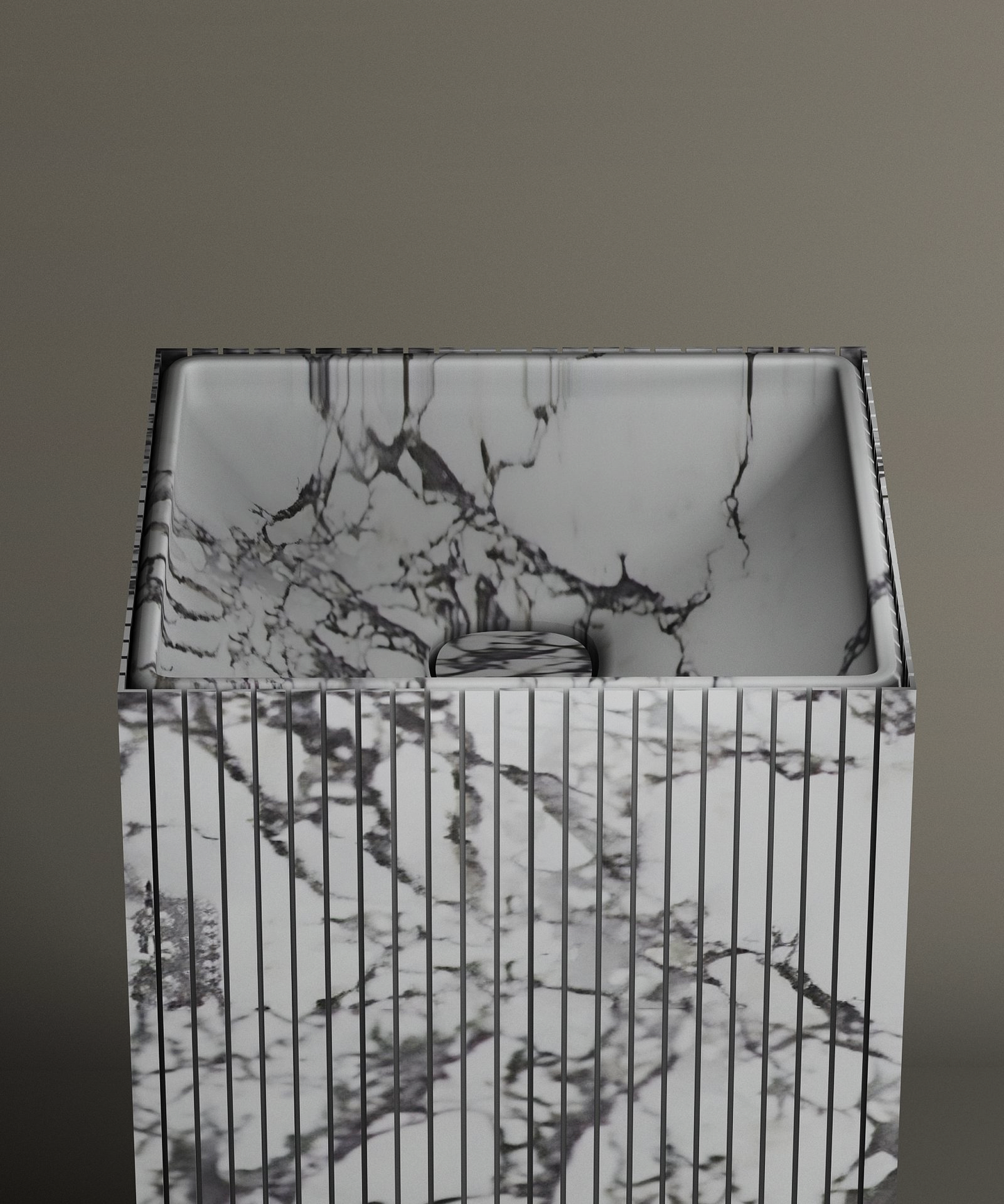 The TRAVERTABLE Calacatta Square Fluted Marble Pedestal Vanity Sink features striking black and white veining, a vertically grooved exterior, and a smooth interior, shown against a simple, neutral backdrop.